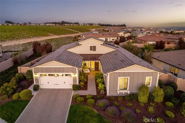 an aerial view of a house with a yard