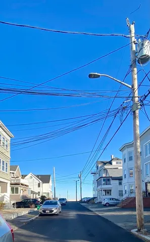 a view of a hallway with wooden floor and stairs
