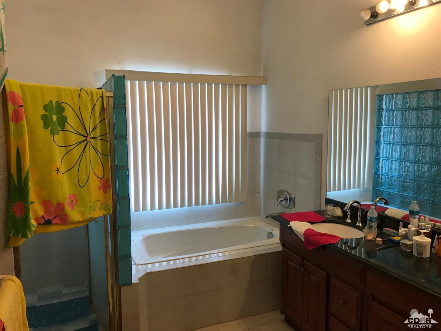 66071 Santa Rosa Road Desert Hot Springs, CA 92240 - Photo 4 of 15 a bathroom with a bathtub and a sink