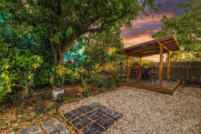 a view of a patio with table and chairs and wooden floor