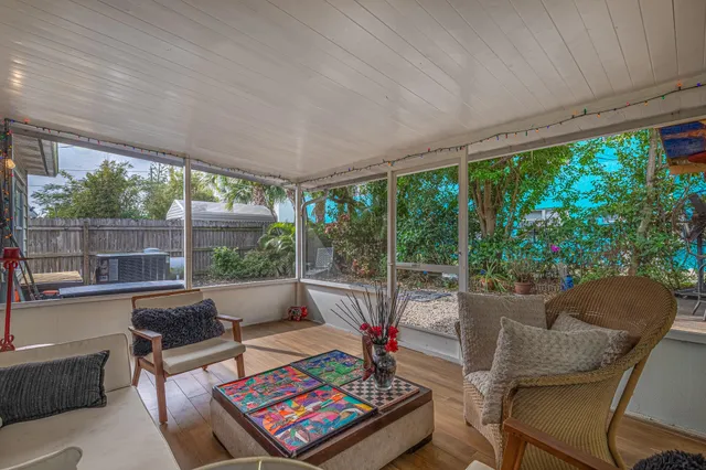 a view of a house with backyard and a tree