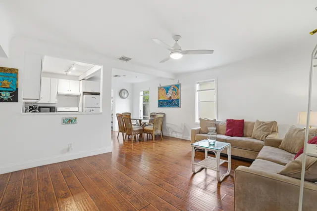 a kitchen with white cabinets white stainless steel appliances and sink