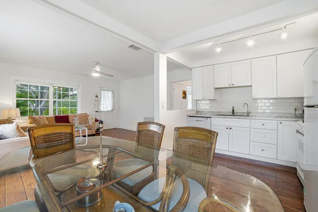 a dining room with furniture and wooden floor