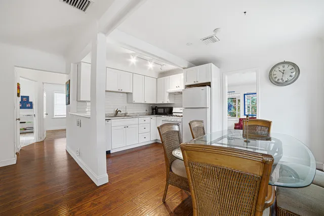 a dining room with furniture and wooden floor