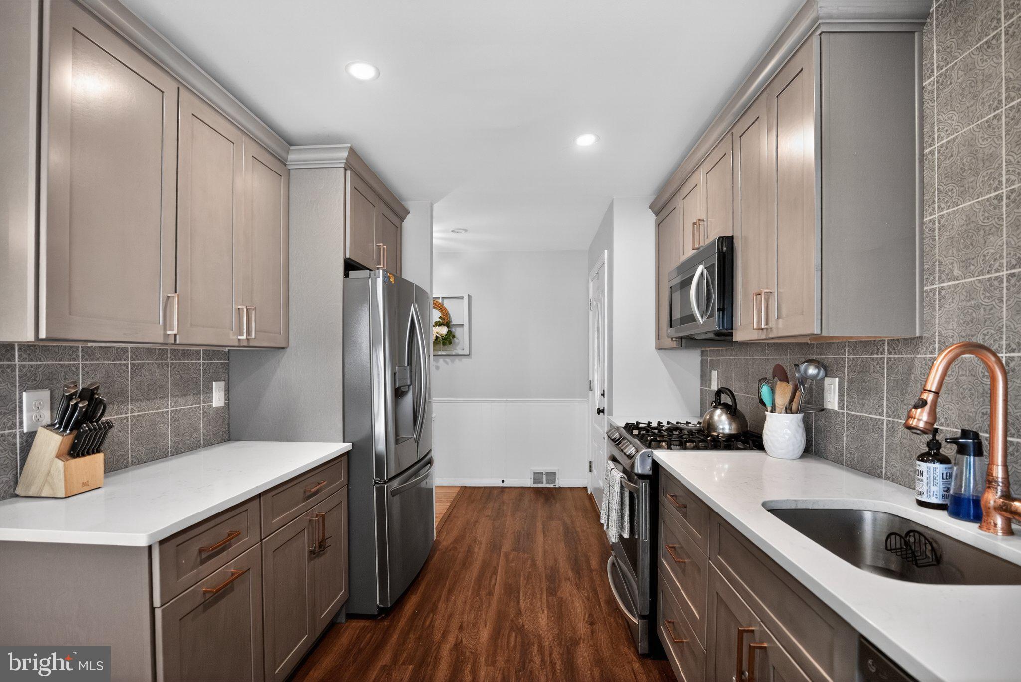 119 Sharrowvale Road Cherry Hill, NJ 08034 - Photo 26 of 36 Sleek modern kitchen with warm tones.