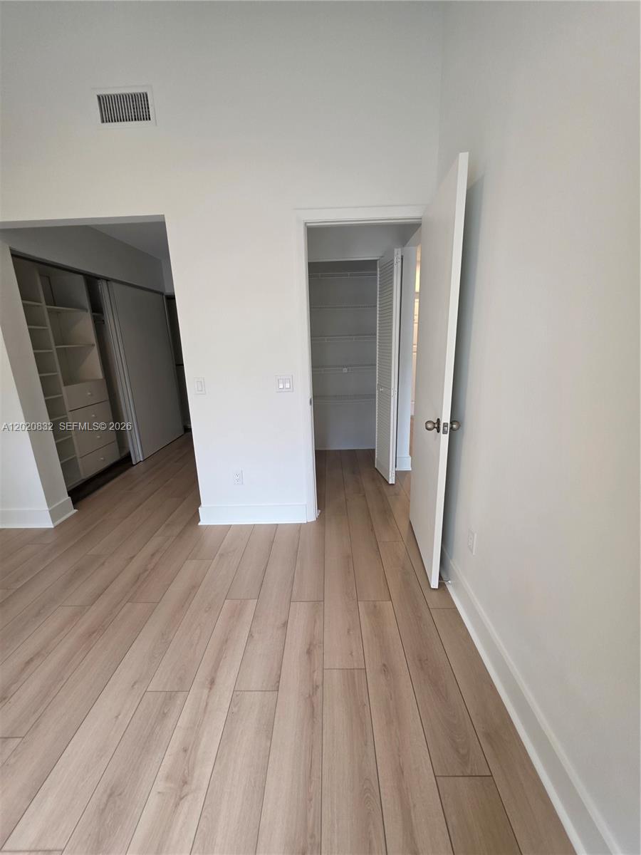 15240 Southwest 45th Terrace, Unit 54F Miami, FL 33185 - Photo 26 of 48 a view of a hallway with wooden floor and closet