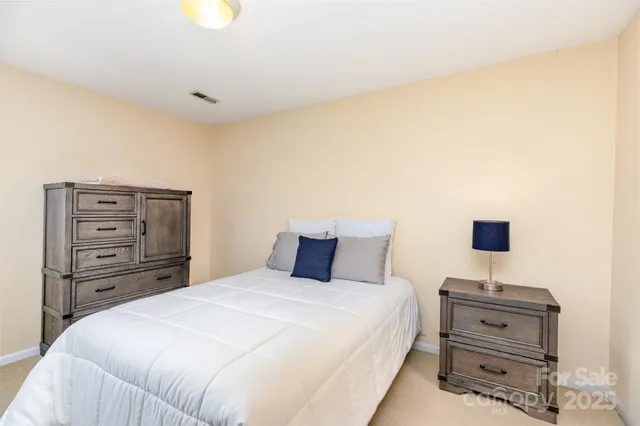 a bedroom with a bed and a tv