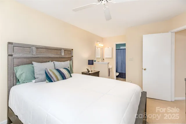 a large bed sitting in a bedroom and a chandelier