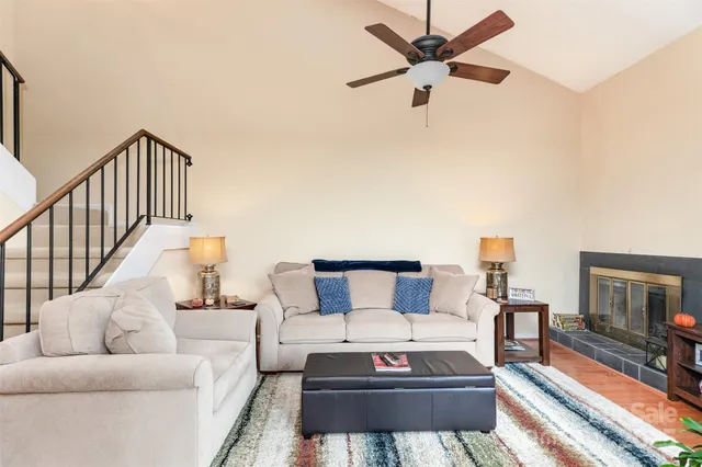 a living room with furniture a flat screen tv and a rug