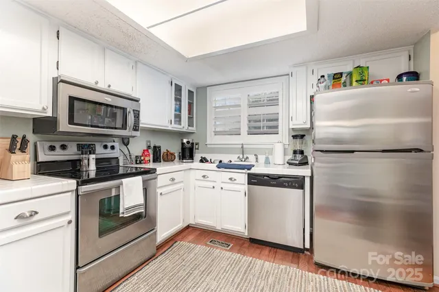 a kitchen with a refrigerator stove and sink