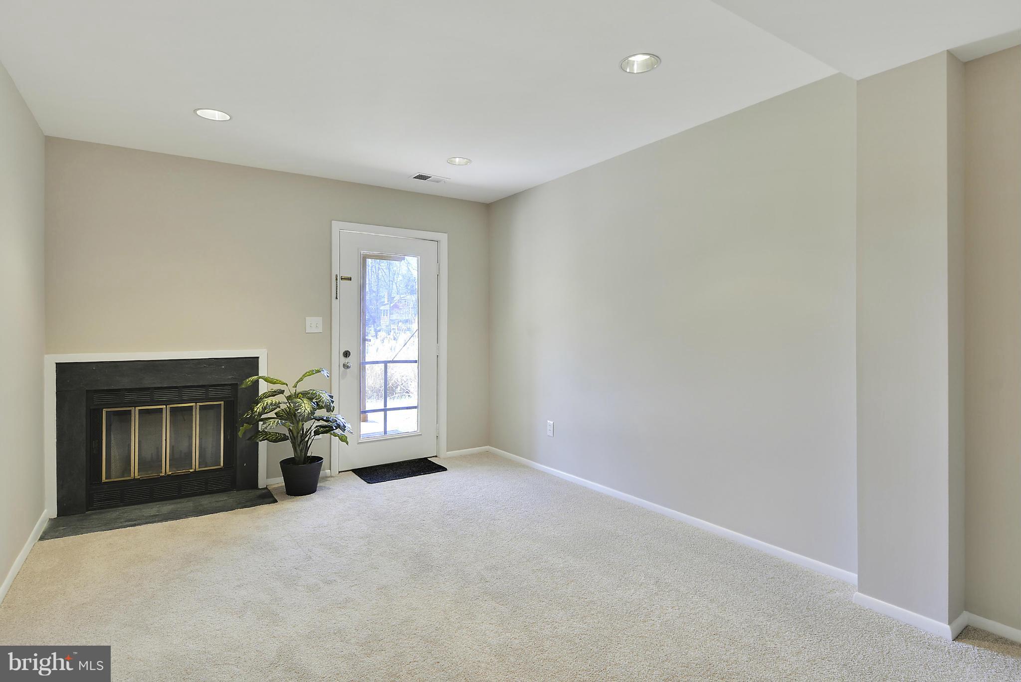 1935 Lakeport Way Reston, VA 20191 - Photo 26 of 30 Open LL Rec Rm w/Wood FP; WO to Deck