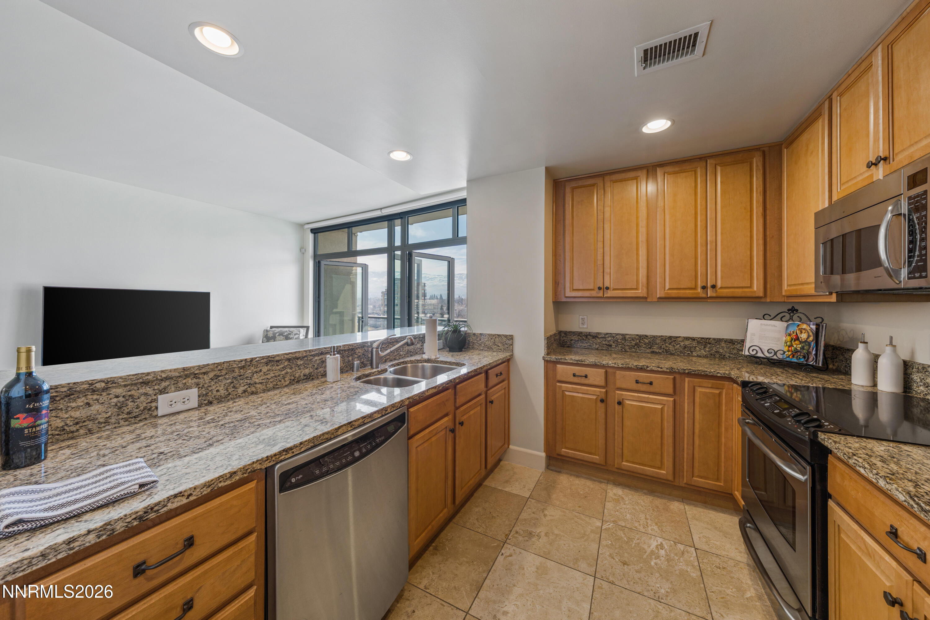 50 North Sierra Street, Unit 903 Reno, NV 89501 - Photo 14 of 61 a kitchen with granite countertop sink stove and cabinets