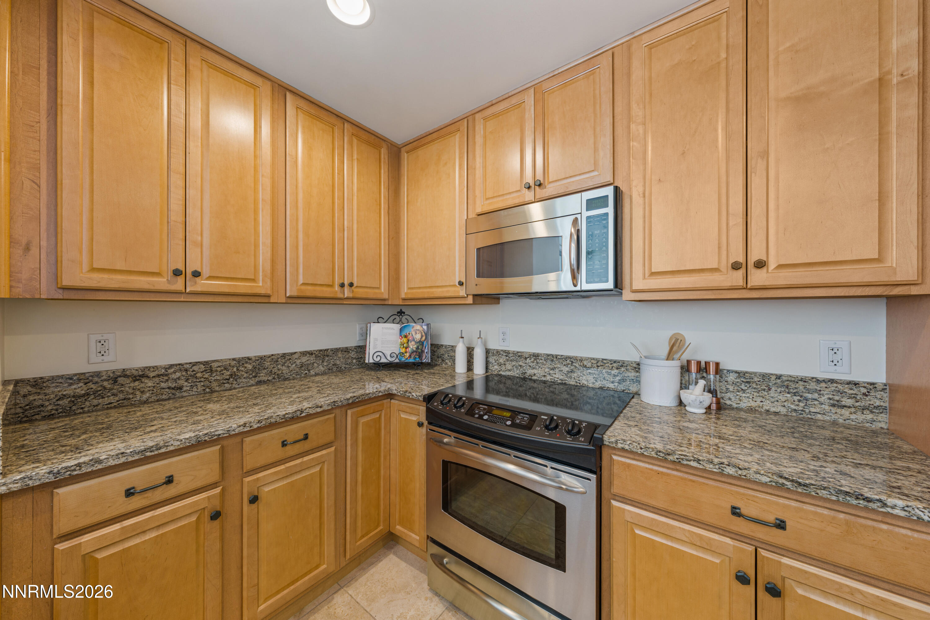 50 North Sierra Street, Unit 903 Reno, NV 89501 - Photo 15 of 61 a kitchen with granite countertop cabinets stainless steel appliances and a counter space