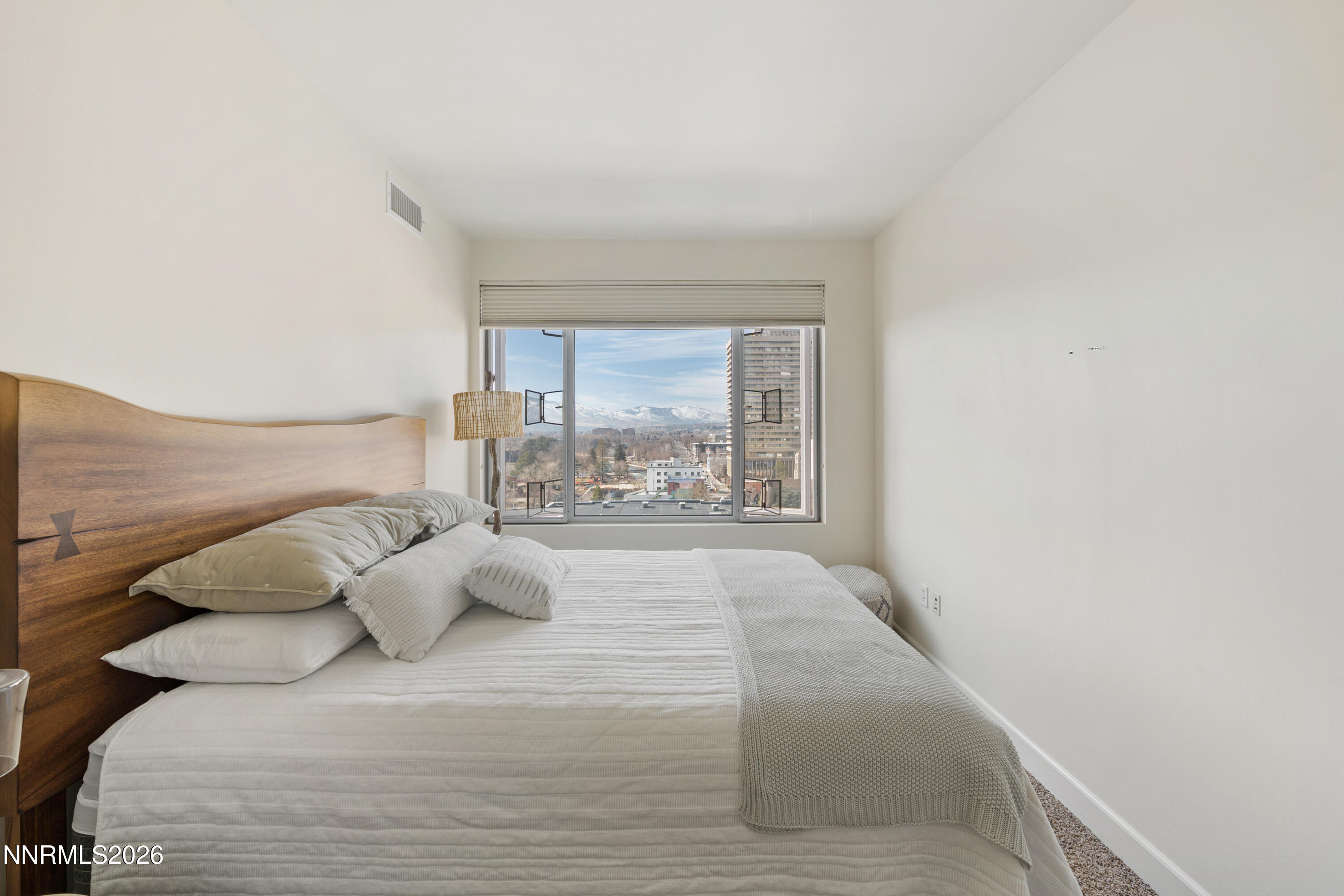 50 North Sierra Street, Unit 903 Reno, NV 89501 - Photo 29 of 61 a large bed sitting in a bedroom next to a window