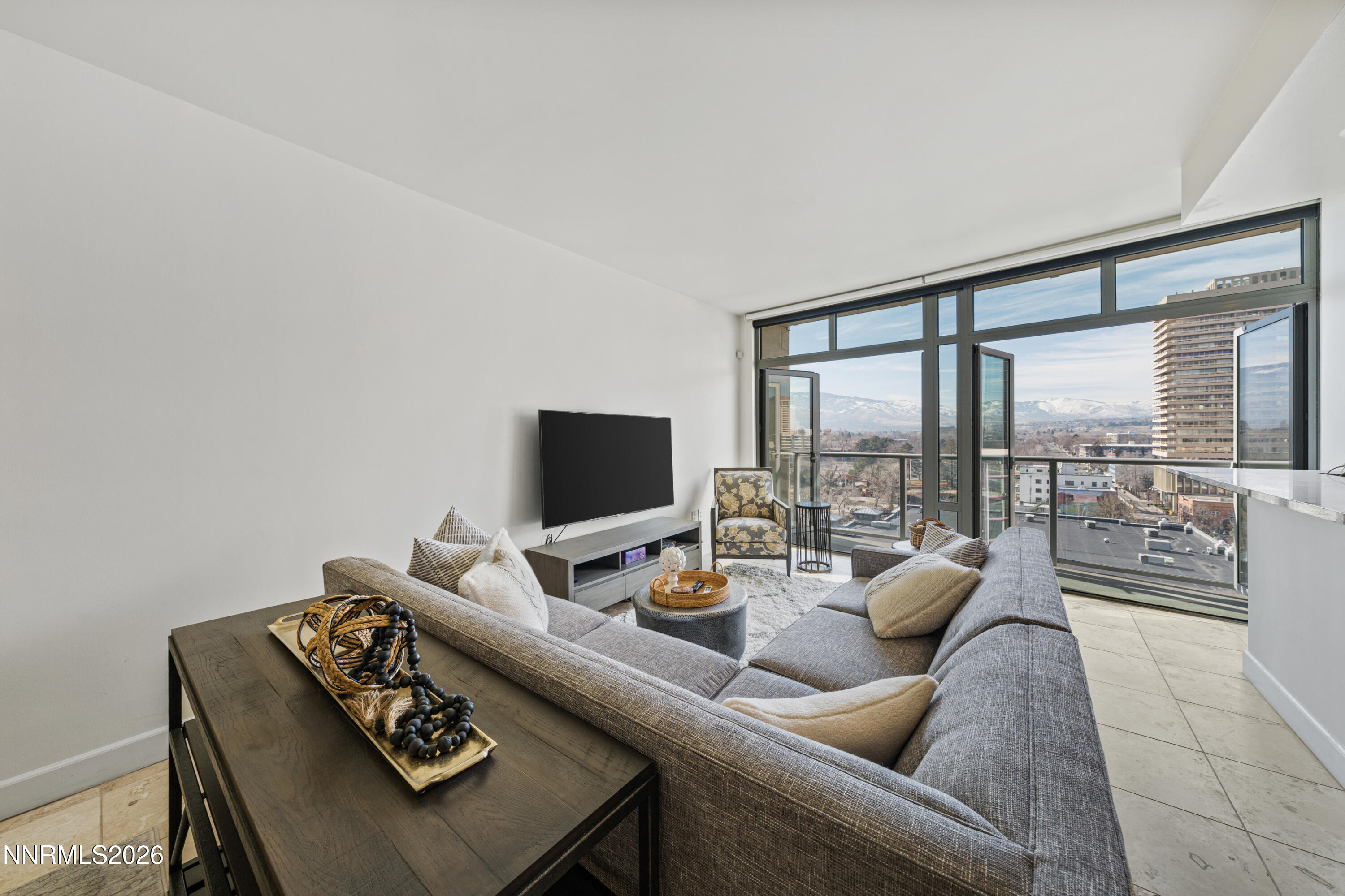 50 North Sierra Street, Unit 903 Reno, NV 89501 - Photo 5 of 61 a living room with furniture and a flat screen tv