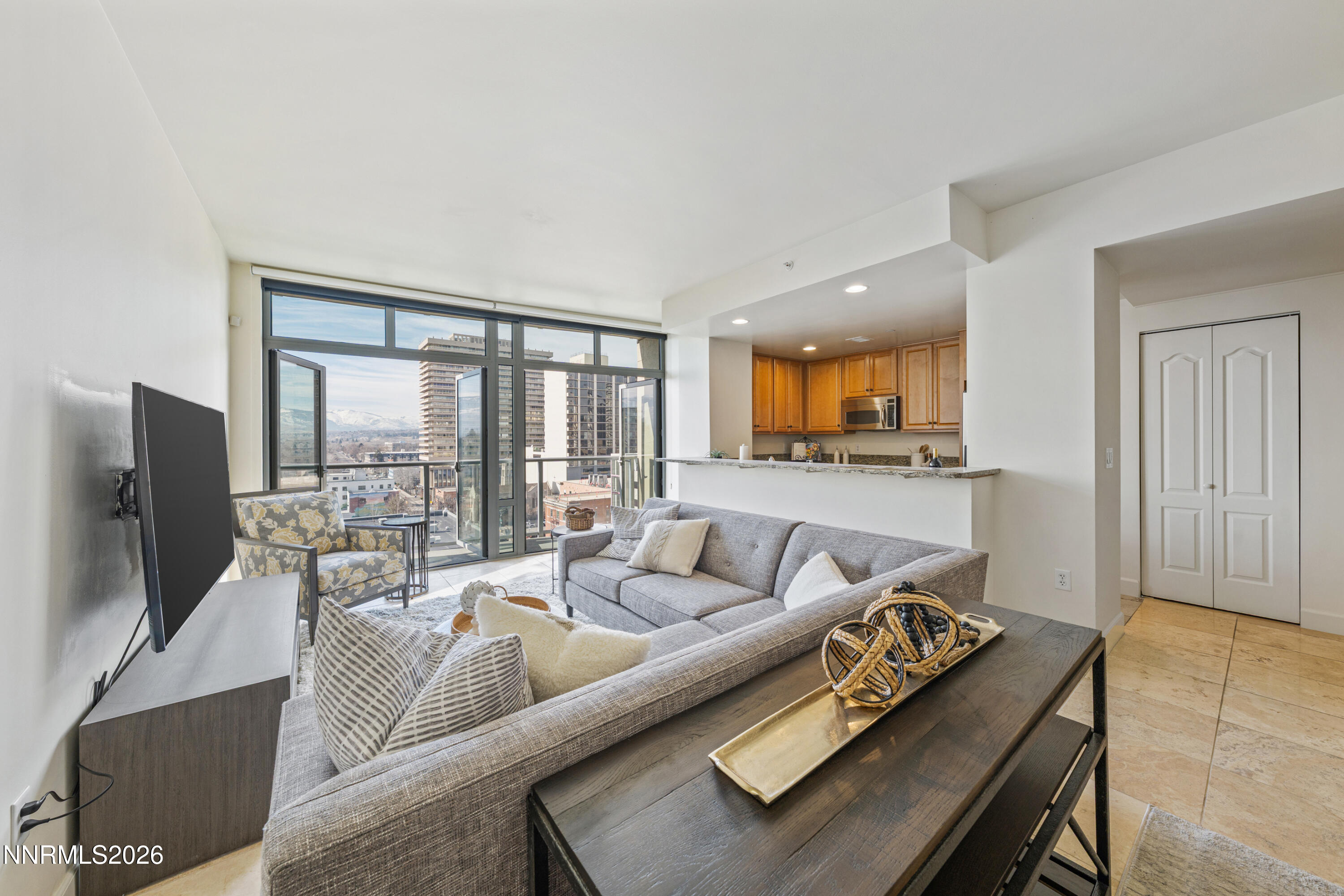50 North Sierra Street, Unit 903 Reno, NV 89501 - Photo 7 of 61 a living room with furniture and a flat screen tv