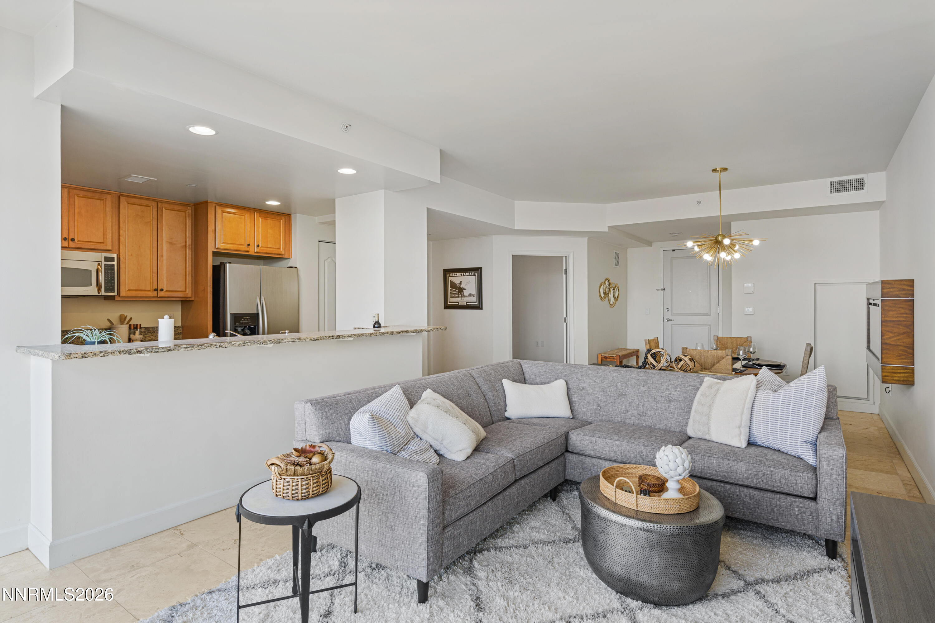 50 North Sierra Street, Unit 903 Reno, NV 89501 - Photo 10 of 61 a living room with furniture a rug and kitchen view