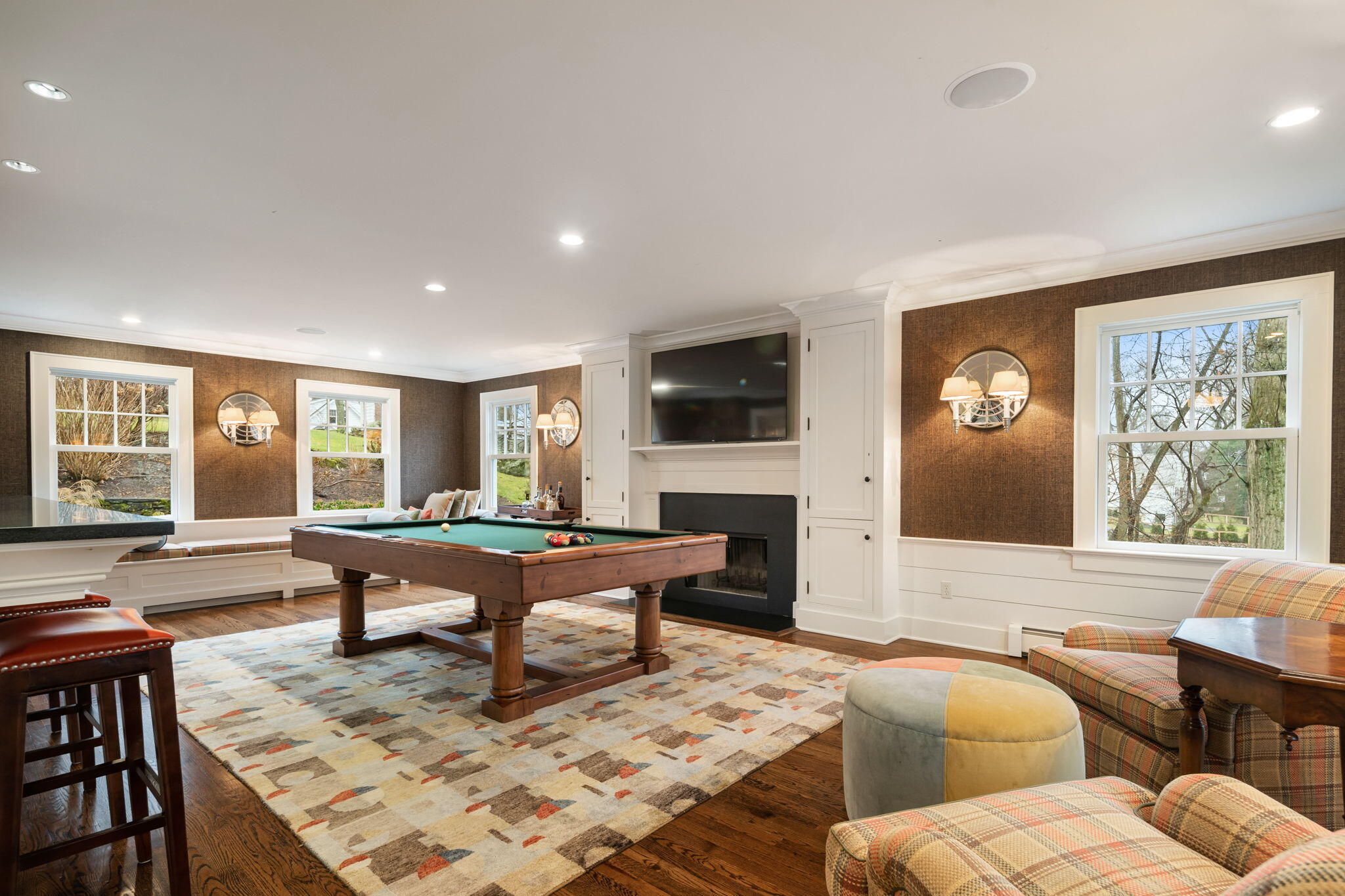 4 Green Beech Drive Rowayton, CT 06853 - Photo 17 of 39 a living room with furniture a fireplace and a flat screen tv