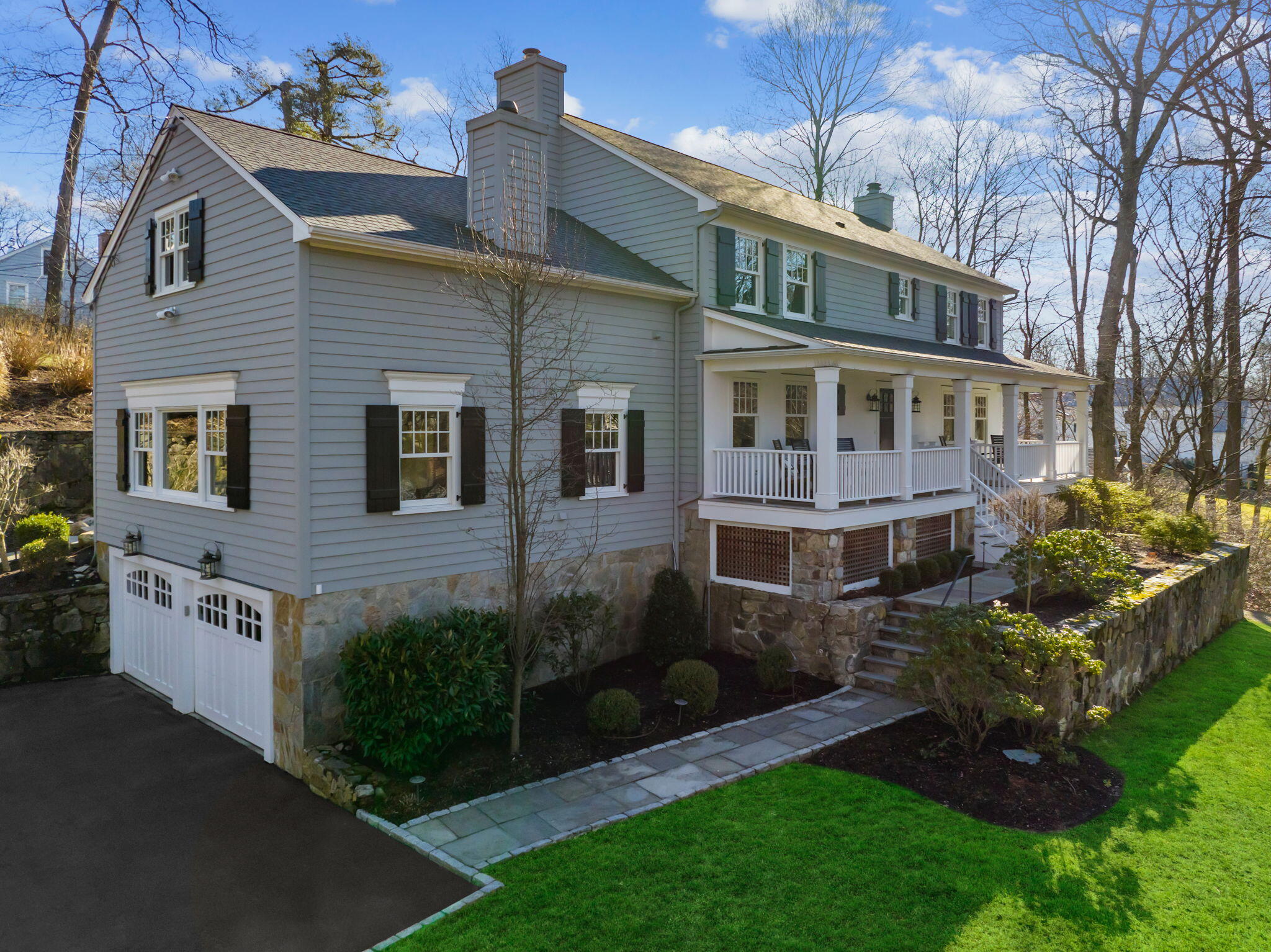 4 Green Beech Drive Rowayton, CT 06853 - Photo 2 of 39 a front view of a house with a garden and plants