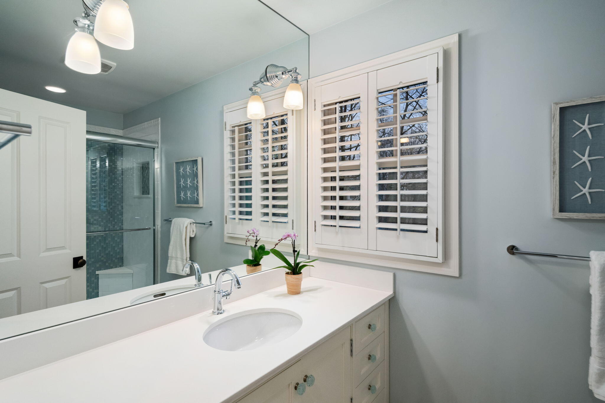 4 Green Beech Drive Rowayton, CT 06853 - Photo 27 of 39 a bathroom with a sink a large mirror and a shower
