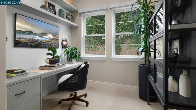 a view of a workspace with furniture and a window
