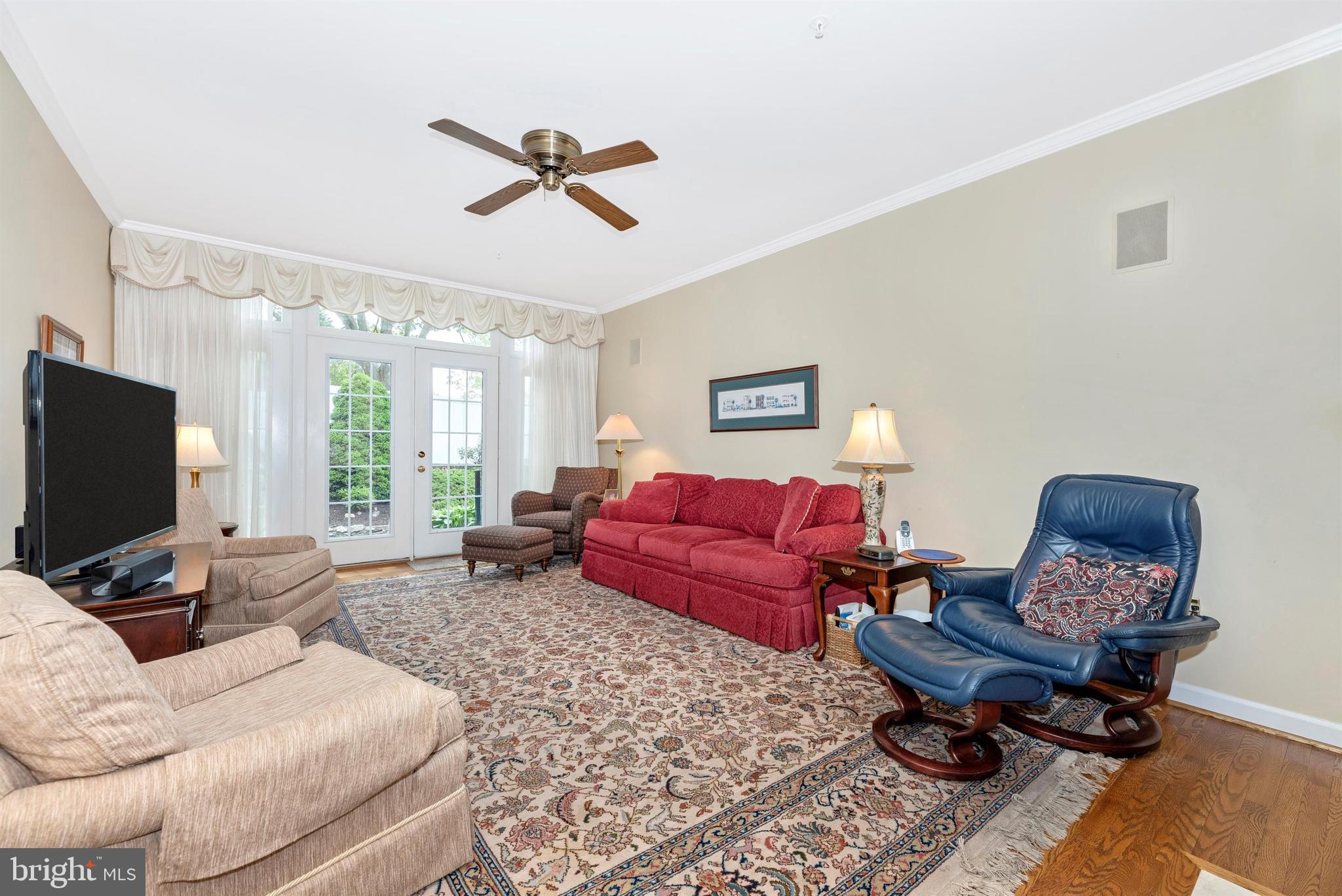 2389 Bear Den Road Frederick, MD 21701 - Photo 7 of 47 Large living room with crown molding and fan.