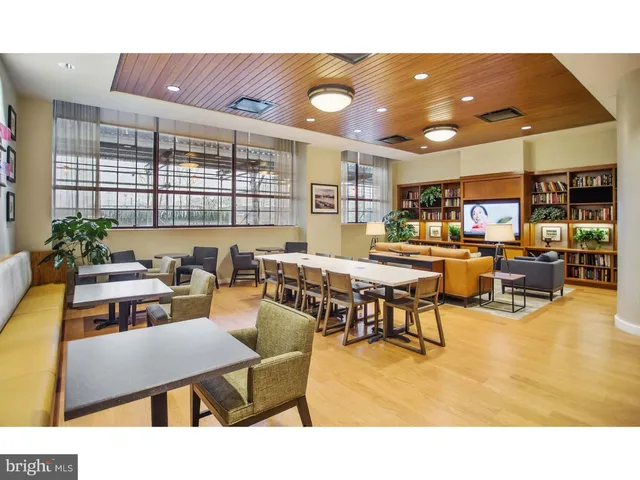 a living room with lots of furniture and a large window