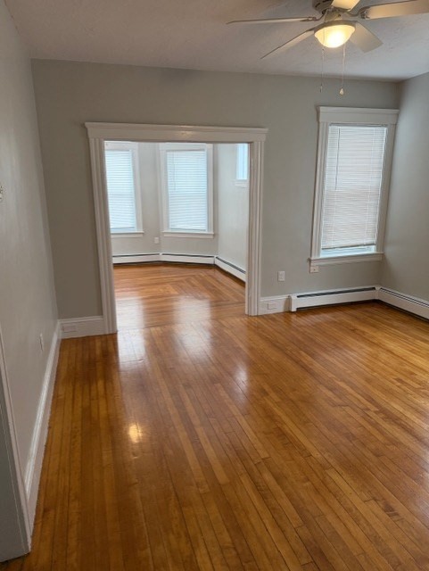 21 Sylvan Street, Unit 1 Worcester, MA 01603 - Photo 5 of 10 an empty room with wooden floor and windows