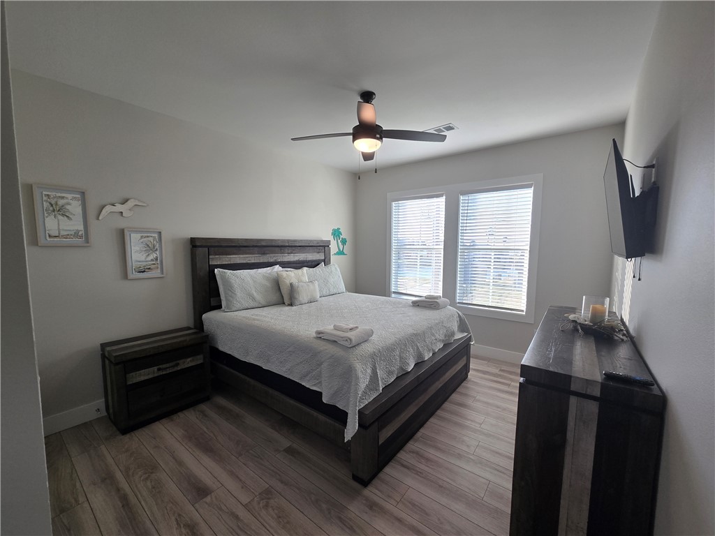 122 Ridge Harbor Drive Rockport, TX 78382 - Photo 22 of 34 a bedroom with a bed and wooden floor
