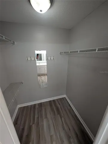 a view of a room with wooden floor and window