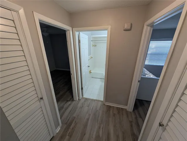 a view of a hallway and wooden floor