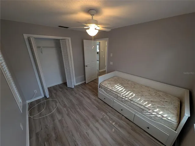 a view of an empty room and wooden floor