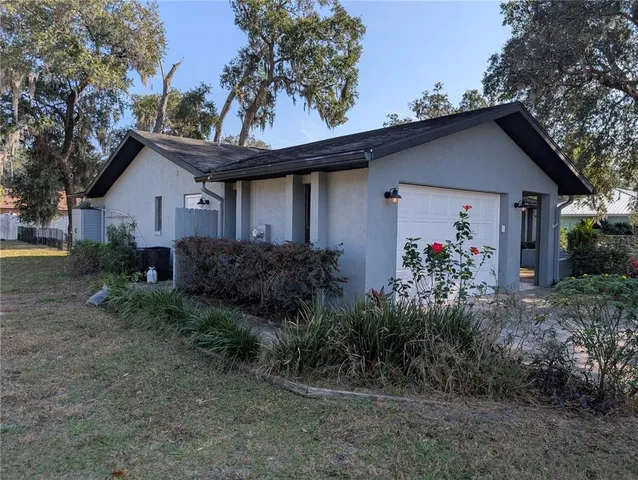 a front view of house with a garden