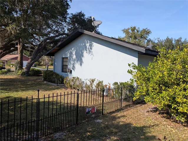 a view of a house with a small yard and plants