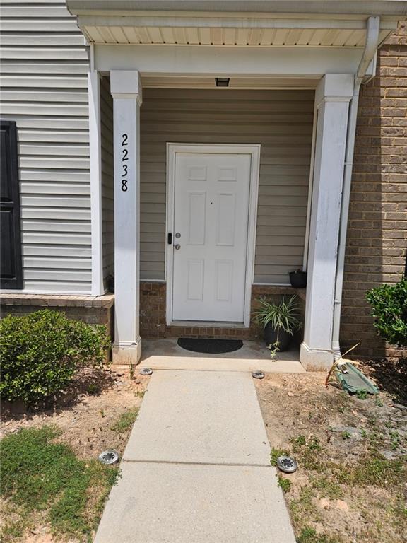 2238 Bigwood Trail Atlanta, GA 30349 - Photo 11 of 20 a front view of a house with a yard