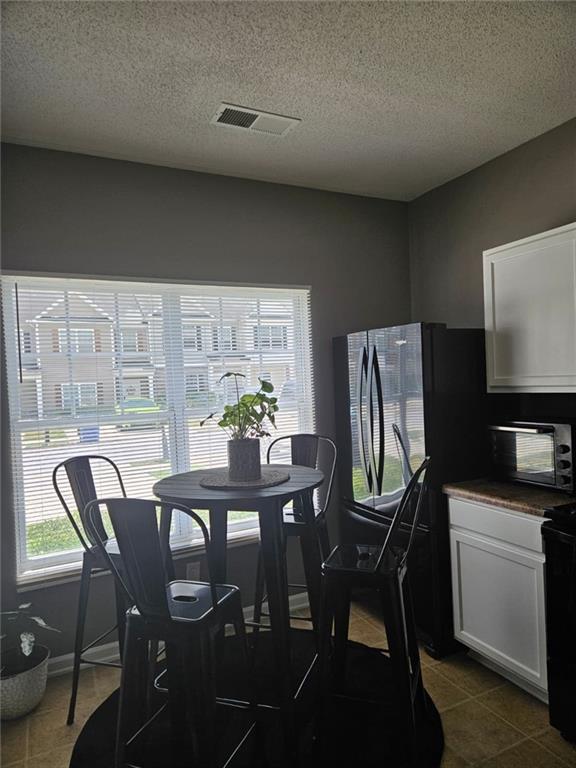 2238 Bigwood Trail Atlanta, GA 30349 - Photo 3 of 20 a view of a dining room with furniture and a potted plant
