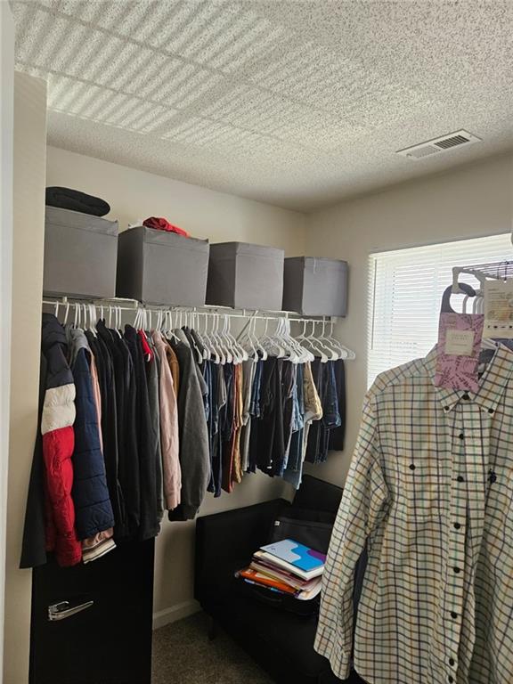 2238 Bigwood Trail Atlanta, GA 30349 - Photo 4 of 20 a walk in closet with clothes and shoes