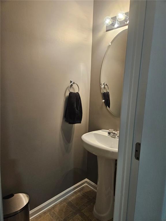 2238 Bigwood Trail Atlanta, GA 30349 - Photo 6 of 20 a bathroom with a sink and mirror with toilet