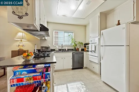 a kitchen with refrigerator and cabinets