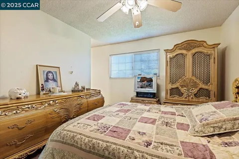 a bedroom with a large bed and a dresser