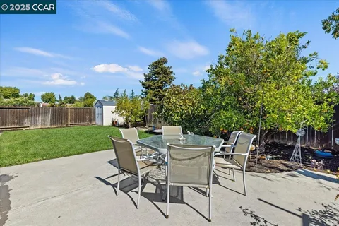 a view of a chairs and table in backyard of the house