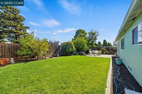 a view of a backyard with sitting area