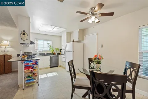 a kitchen with refrigerator and cabinets
