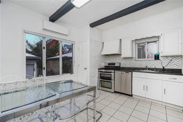 a kitchen with granite countertop a sink and a stove
