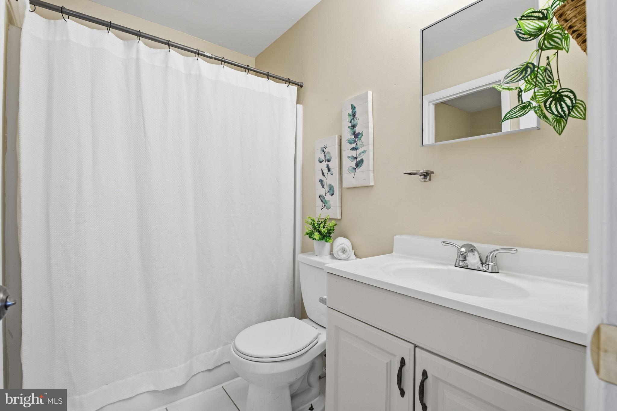 21 Ute Court Middle River, MD 21220 - Photo 24 of 36 a bathroom with a sink a toilet and a mirror
