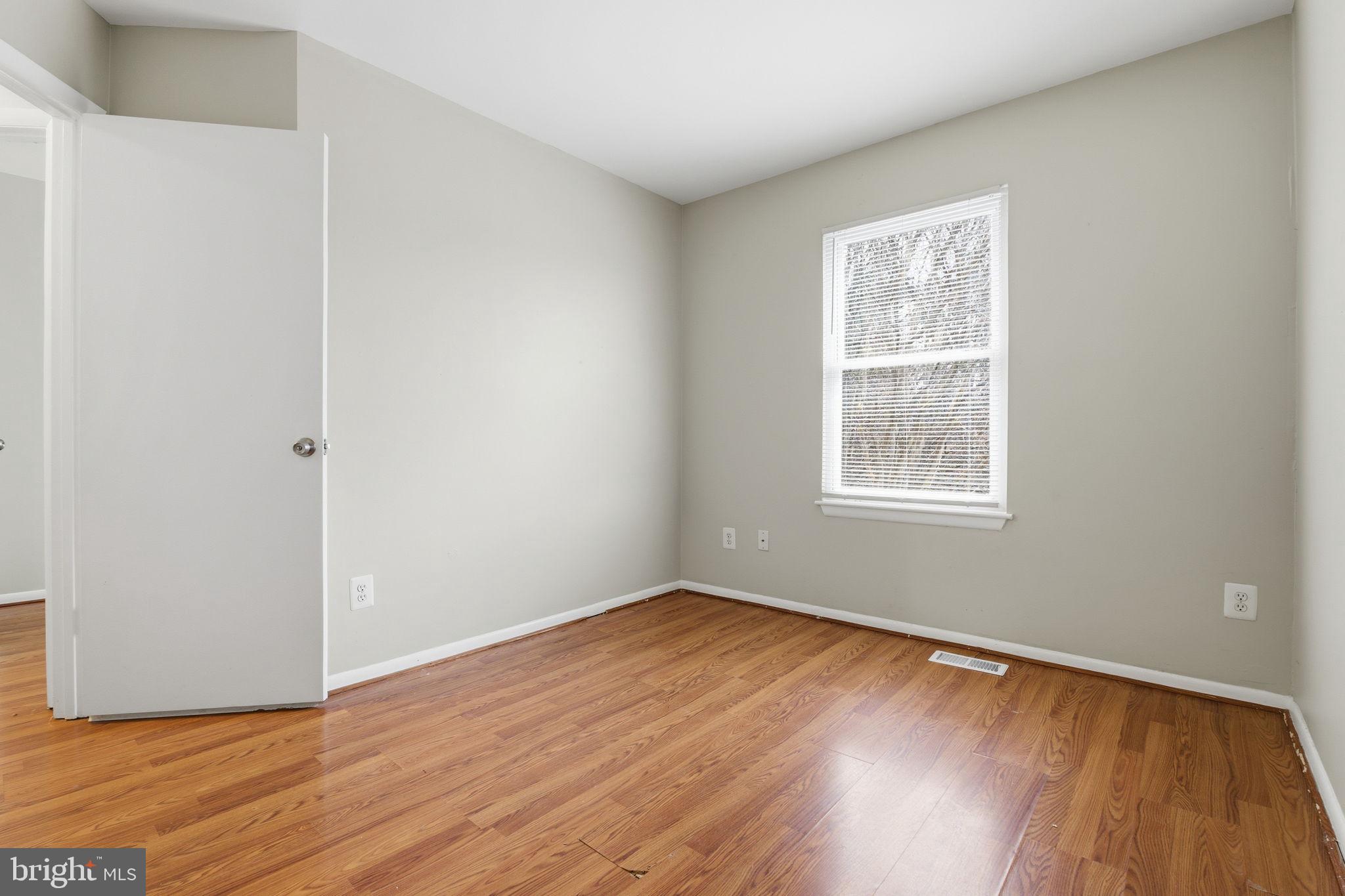 21 Ute Court Middle River, MD 21220 - Photo 30 of 36 an empty room with wooden floor and windows
