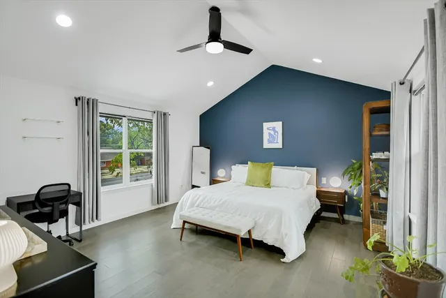 a bedroom with a bed and a view of balcony
