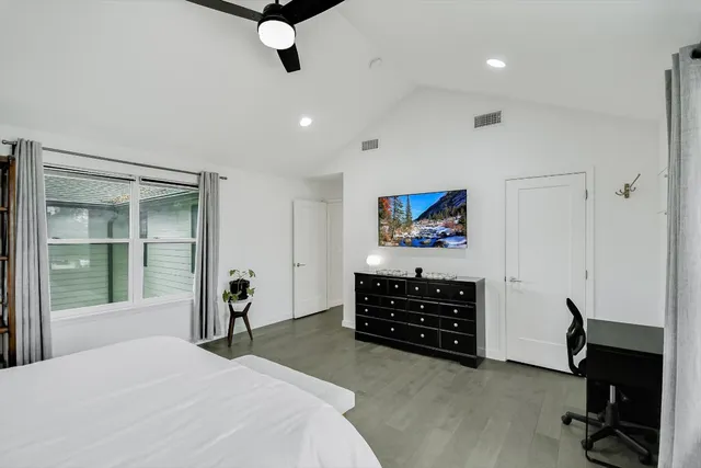 a bathroom with a granite countertop sink a toilet and a mirror