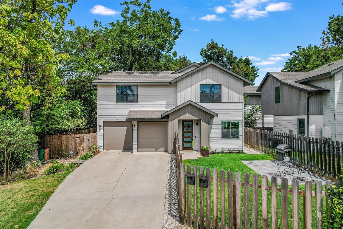2414 East Martin Luther King Jr Boulevard, Unit A Austin, TX 78722 - Photo 26 of 32 a front view of a house with a yard and potted plants
