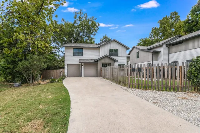 a view of a house with a yard and sitting area